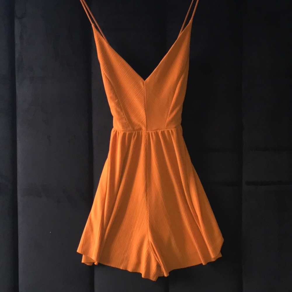 Orange pleated flowy romper